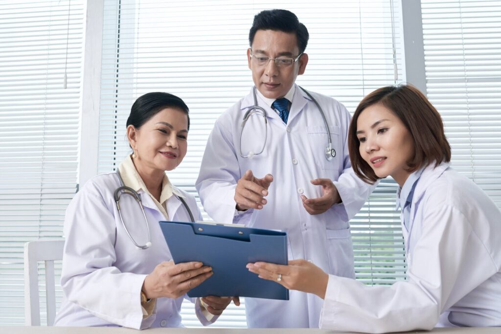 two-nurses-reporting-chief-doctor_