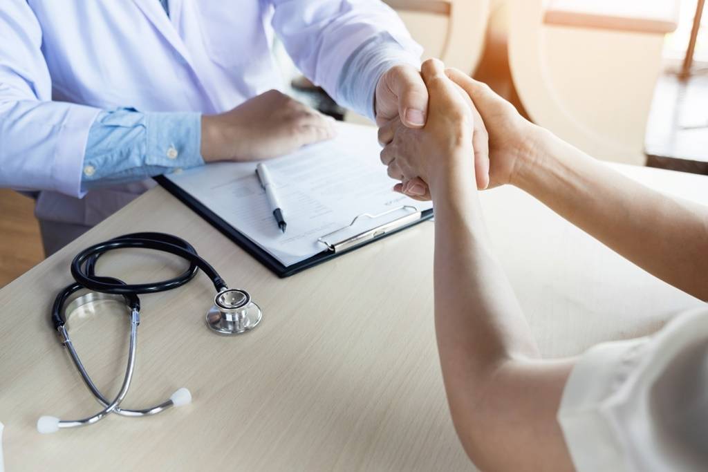 doctor-shakes-hands-medical-office