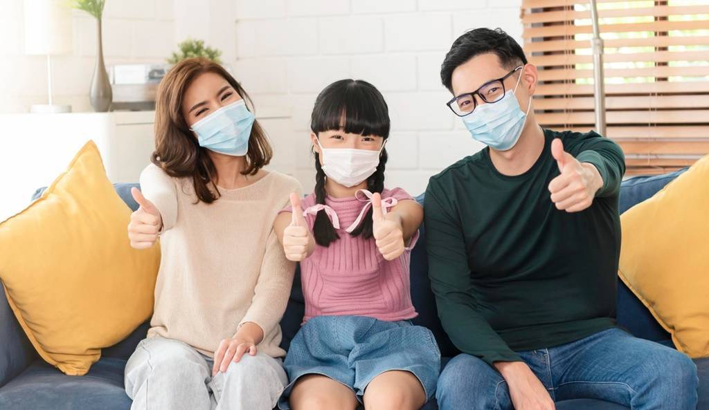 happy-asian-family-wearing-mask-protect-against-viruses-hand-thumbs-up-home-living-room